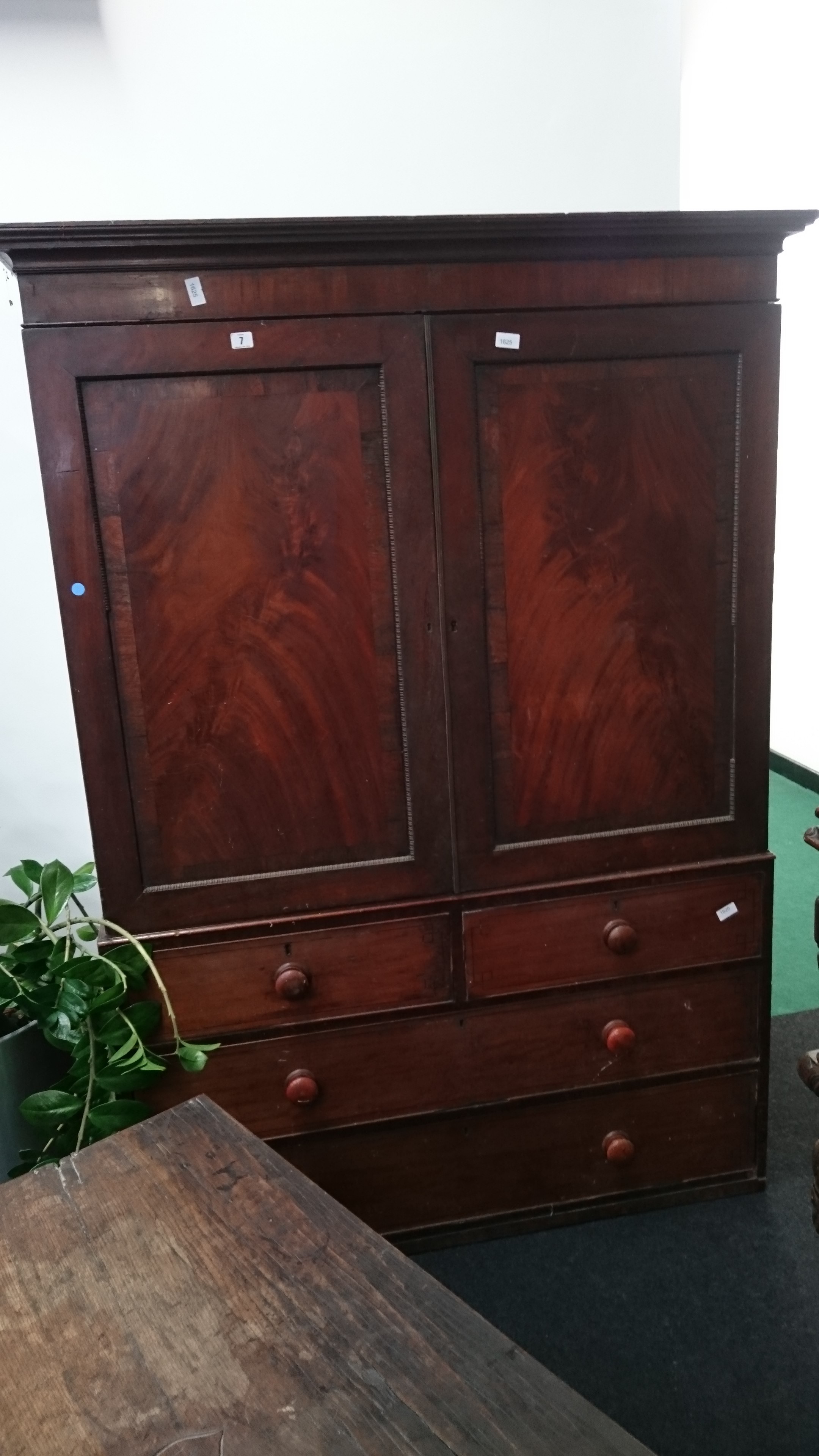 A large 19th century flame mahogany linen press with fitted interior.