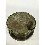 A 19th century metal fishing reel inscribed A. & N. CSL, 105 Victoria Street, SW.