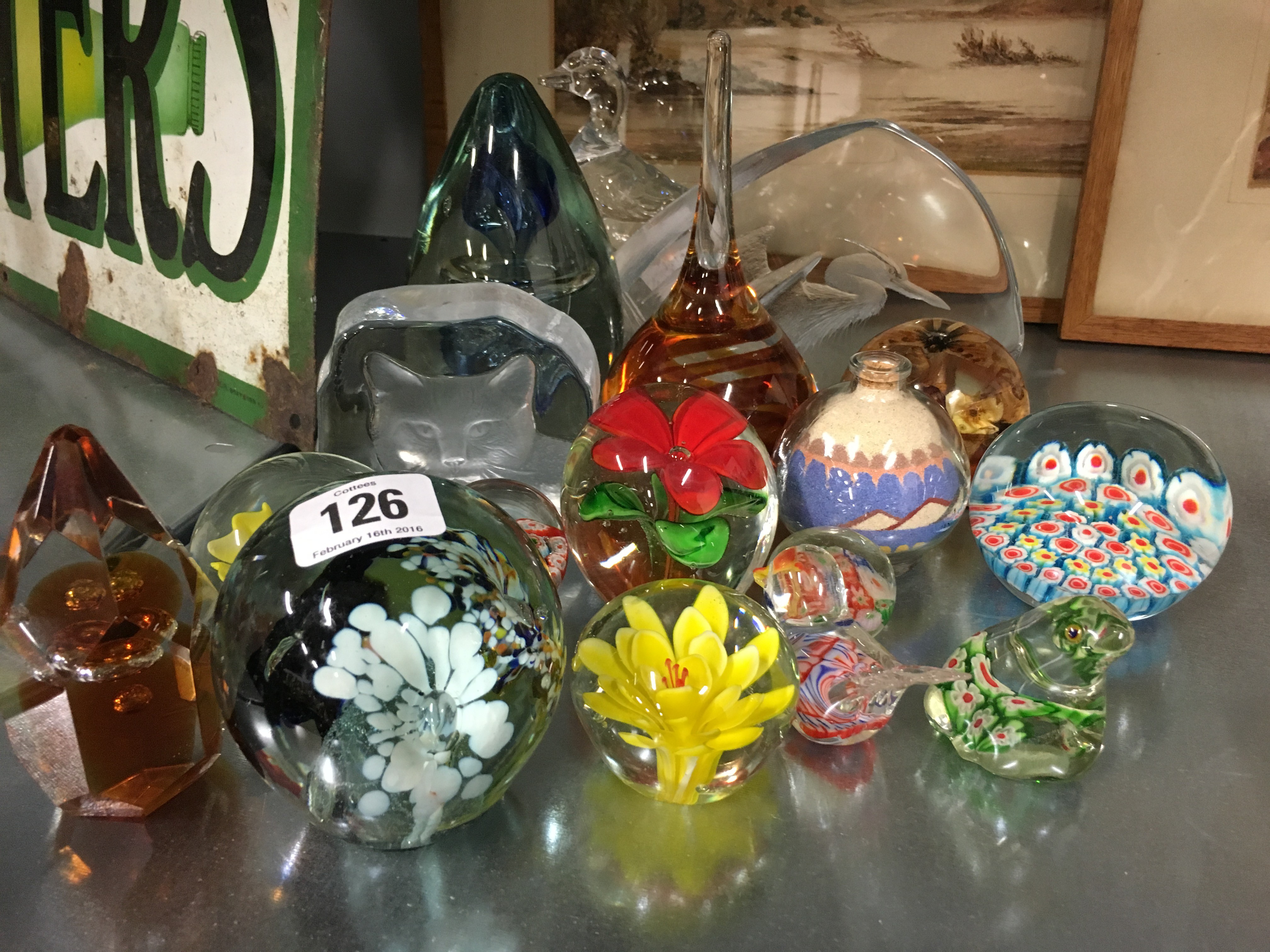 A collection of various glass paperweights.