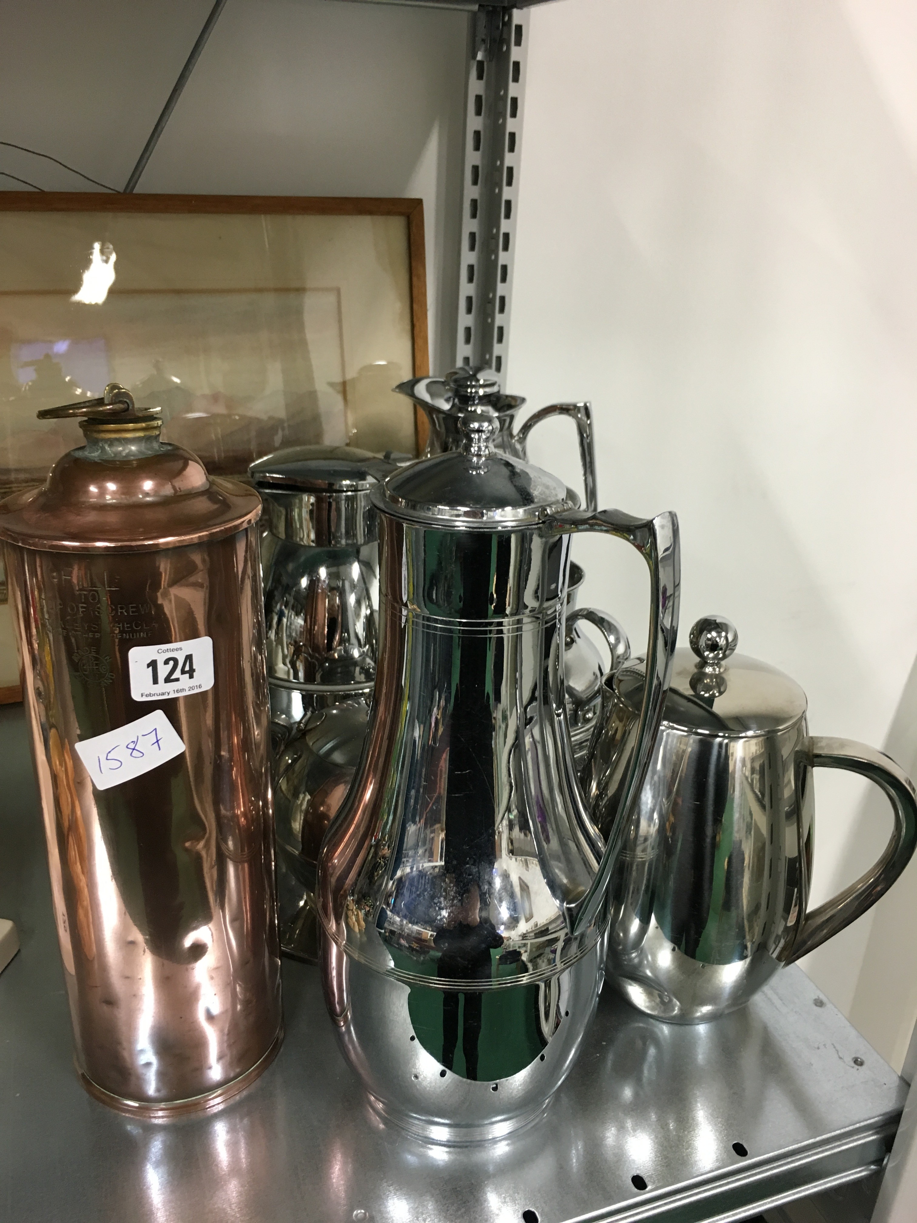 A collection of various stainless steel and chrome plated tea and coffee pots including Thermos