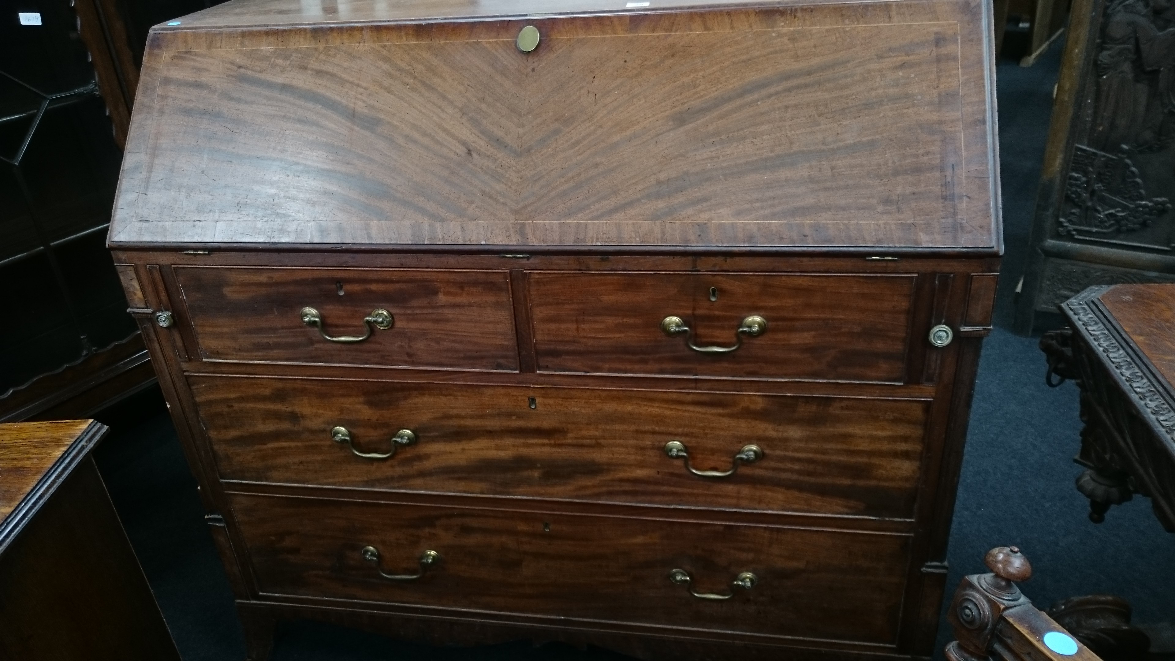 A large flame mahogany bureau with boxwood stringing,