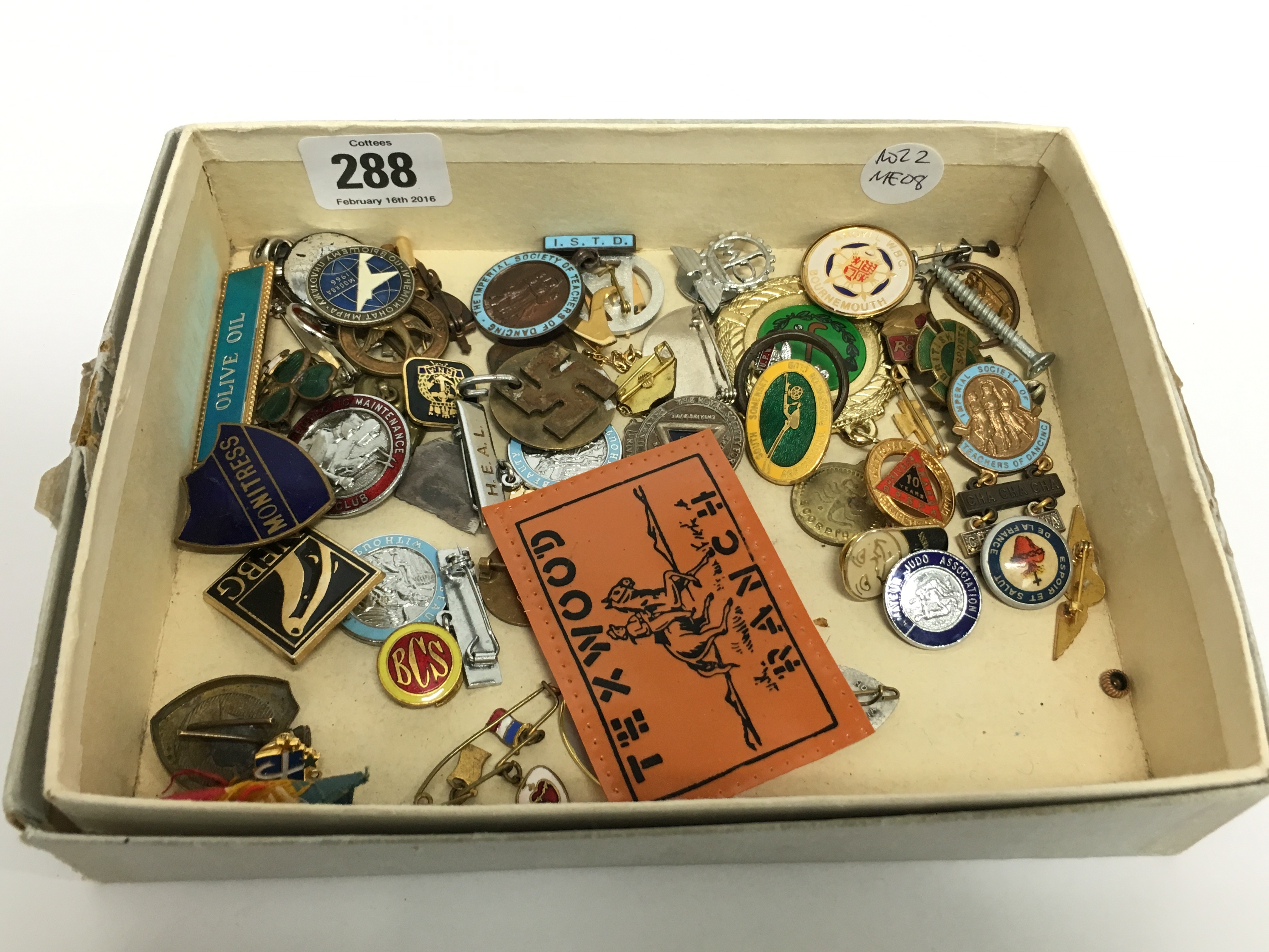 A carton containing various enamel and other badges.