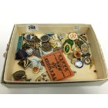 A carton containing various enamel and other badges.