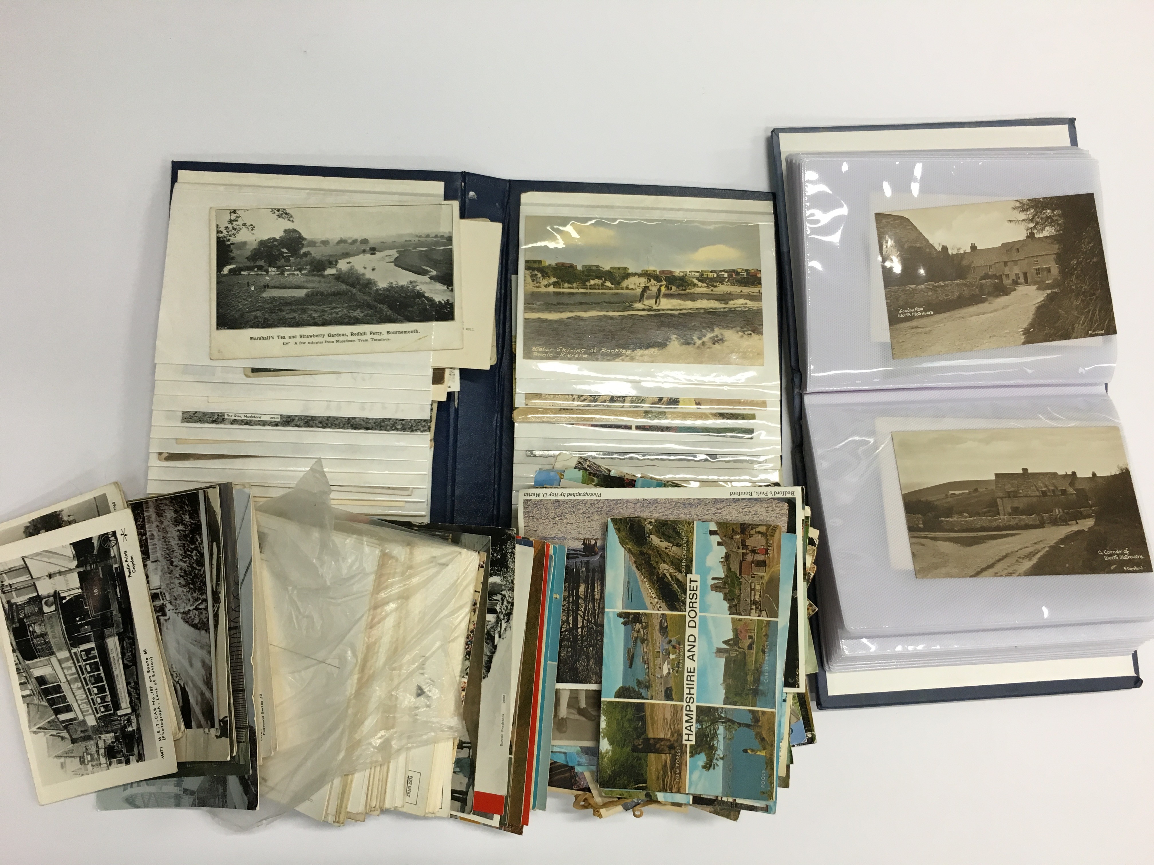 A box containing two postcard albums and contents together with various unsorted postcards.