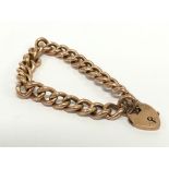 An antique 9 carat rose gold padlock clasp curb bracelet.