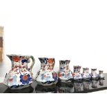 A set of seven graduated 19th century Masons Ironstone jugs decorated in traditional colours in a