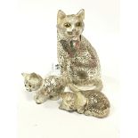 Three silver metal ornamental cats.