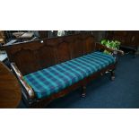 A large oak panelled hall bench resting on pad feet with upholstered cushion seating.