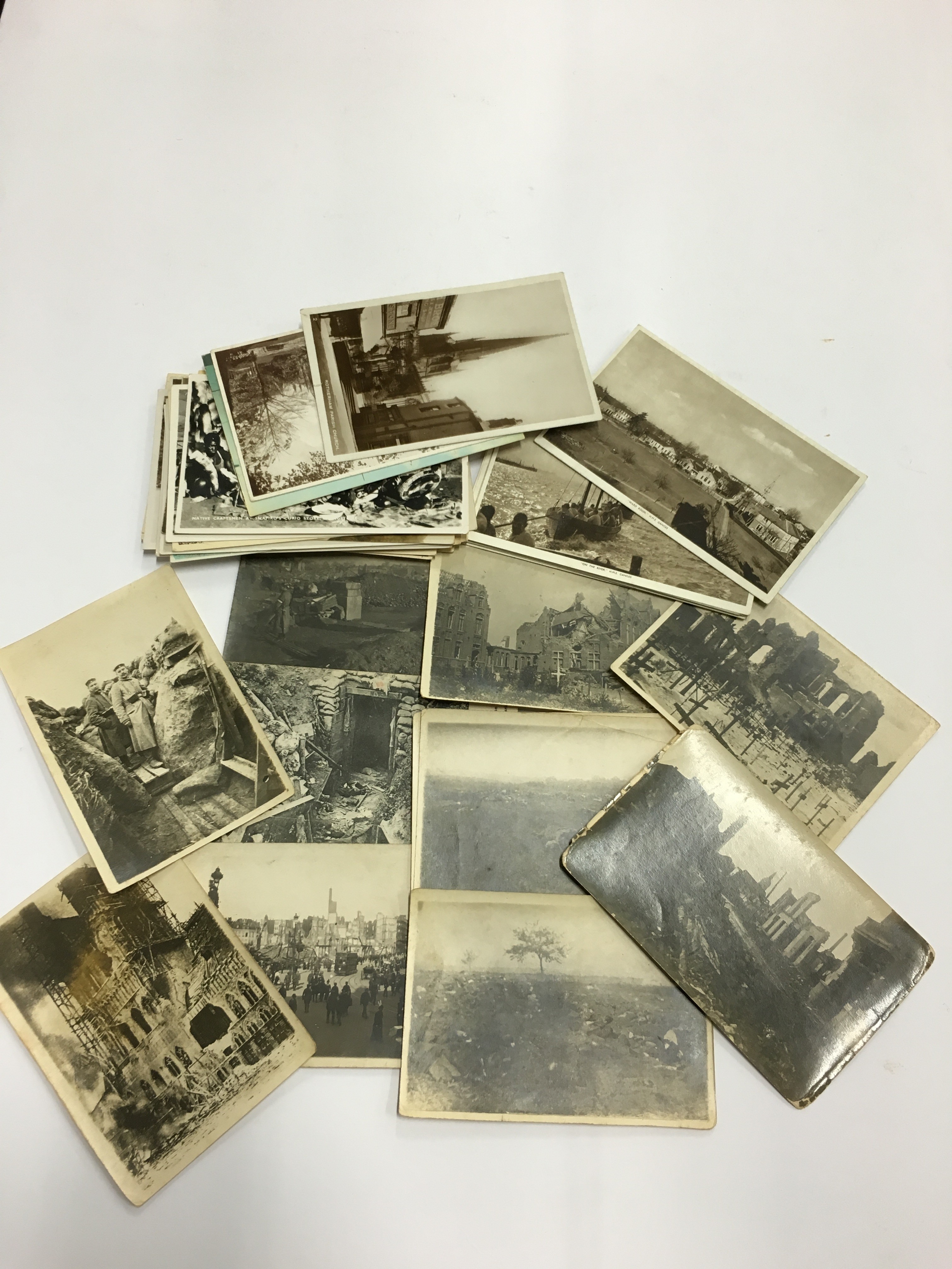 A small quantity of various early 20th century black and white postcards and photo cards including