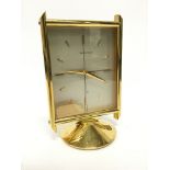 A mid 20th century mantle clock by Jaeger-Le-Coultre, brass and glass cased in the modernist style.