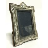 A small silver photograph frame together with two silver plated photograph frames.