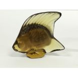 A miniature Lalique amber tinted model of a fish.