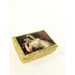 A gilded metal and enamel snuff box with risque lid decorated with a reclining nude female.