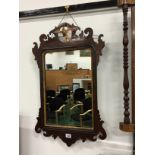 A 19th century carved mahogany mirror with Ho-ho carved bird surmount.