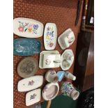 A collection of various white bodied and other Poole Pottery items.