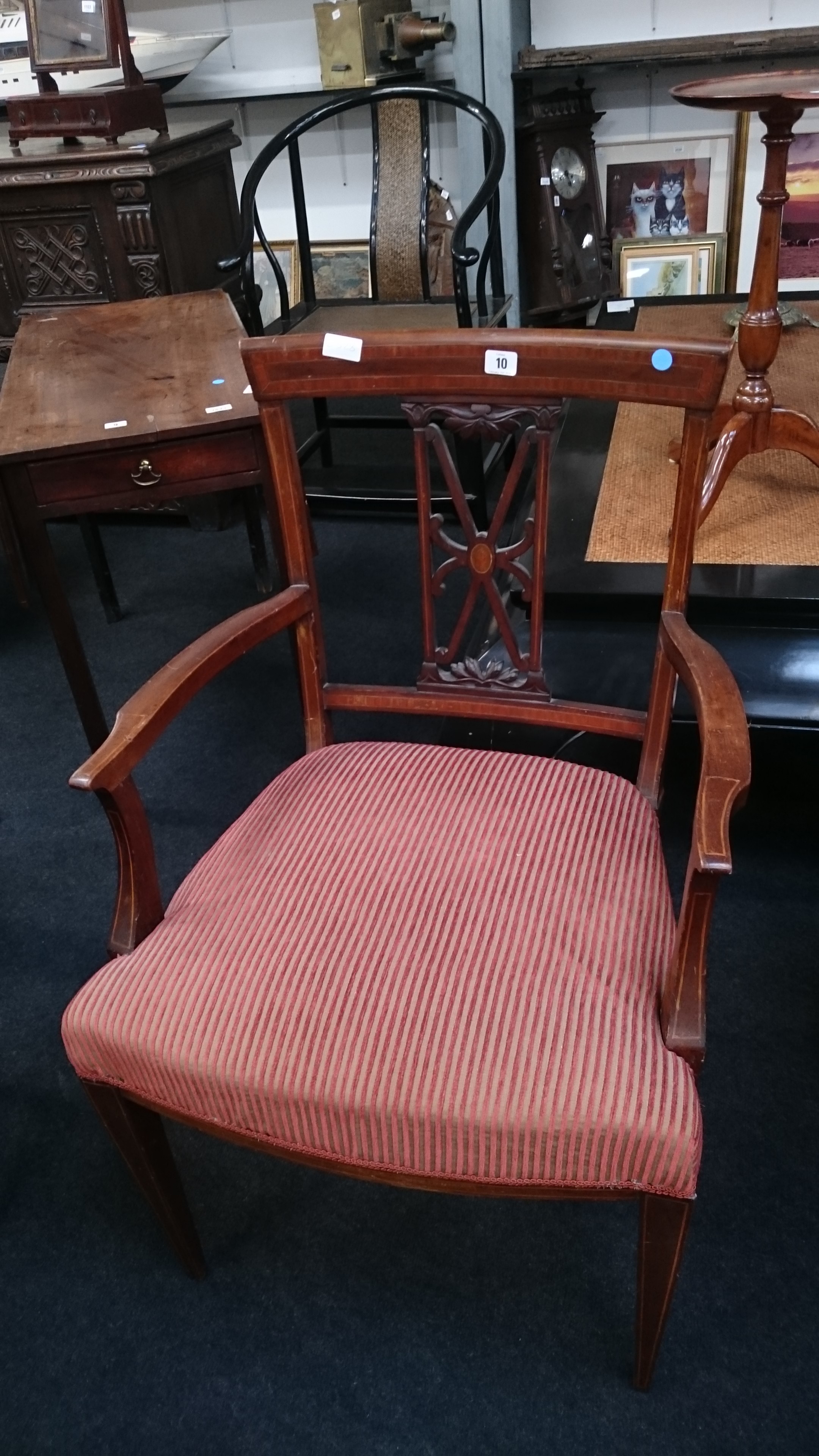 A mahogany inlaid carver dining chair with upholstered seat, resting on tapered supports.