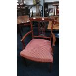 A mahogany inlaid carver dining chair with upholstered seat, resting on tapered supports.