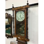 A late 19th century marquetry inlaid regulator wall clock with brass pendulum and mirror back.