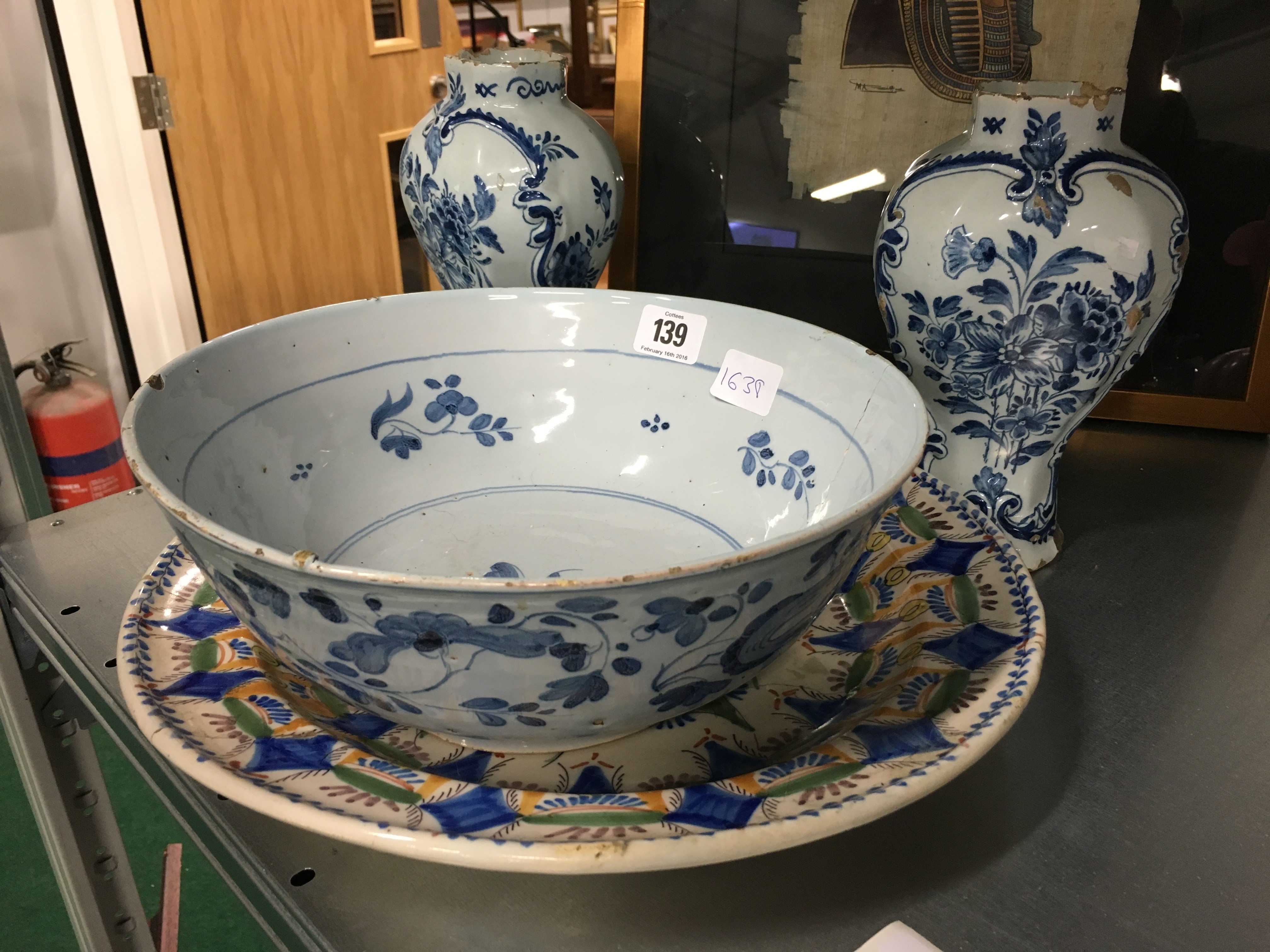 An early Delft china bowl decorated with stylised leaves (examine) together with a pair of Delft