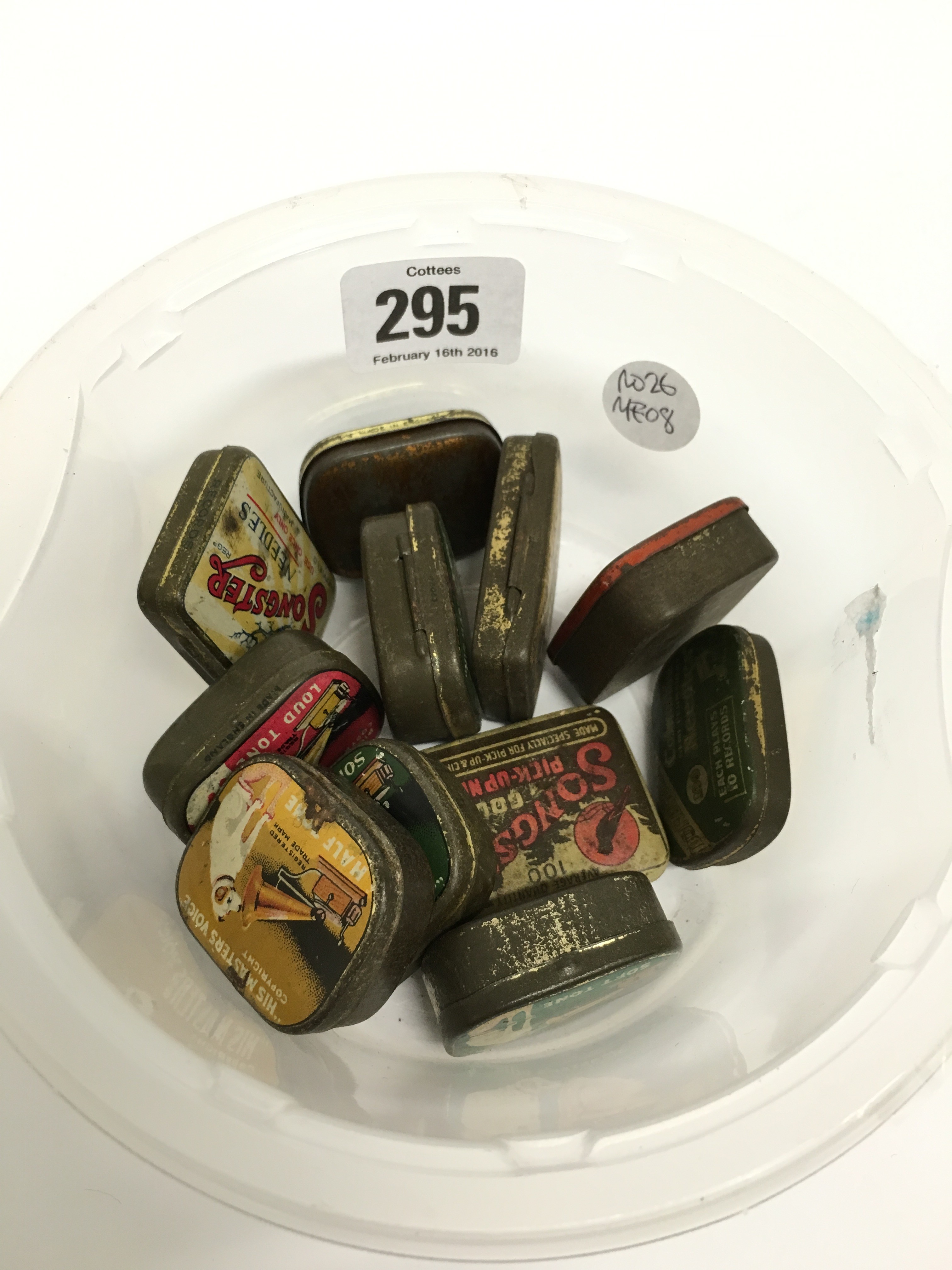 A carton containing eleven various early 20th century gramophone needle tins.