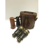 A pair of early 20th century binoculars together with a brown leather Military binocular case and a