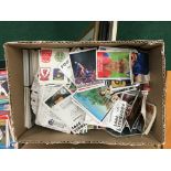 A box containing a quantity of various Merlin and Panini stickers and cards.