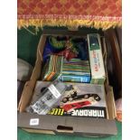 A box of children's books and other items.