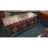 A large oak carved panelled coffer.