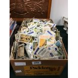 A box containing a large quantity of unsorted tea cards.