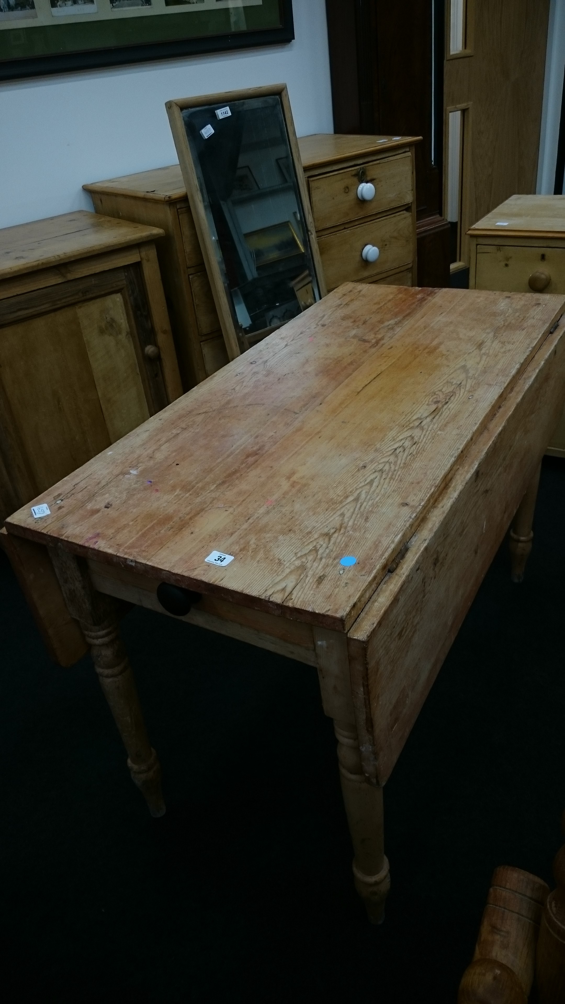 A pine scrub top drop-flap farmhouse kitchen table with cutlery drawer to end,