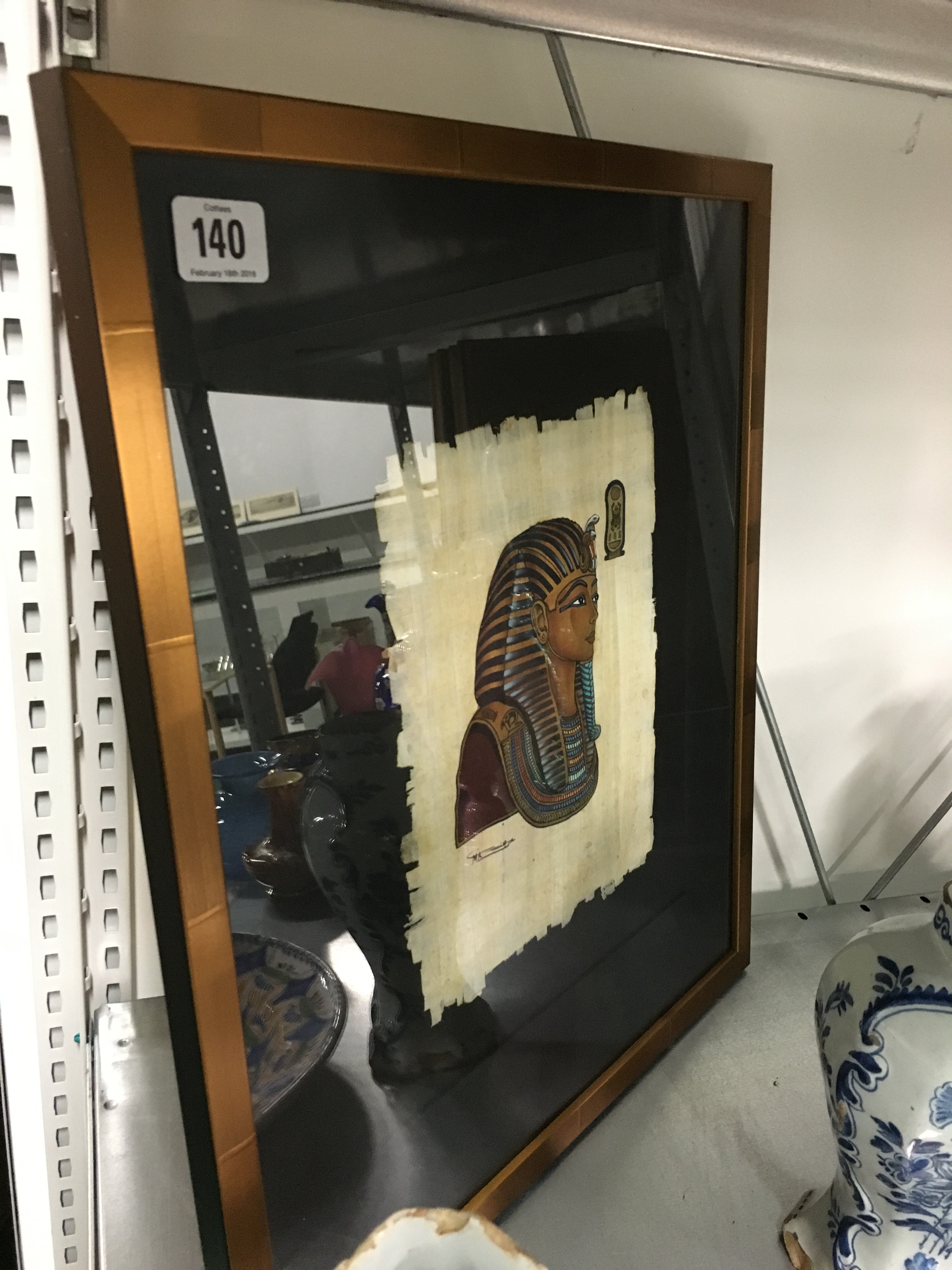 A framed and glazed fabric painting: Tutankhamun.