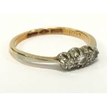 An 8 carat gold three stone diamond ring.