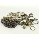 A bag of mixed silver jewellery items.