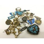 A bag containing a quantity of silver, enamel and other jewellery,