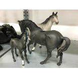 A Beswick china matt black glazed model of a Stallion together with a grey glazed Stallion and a