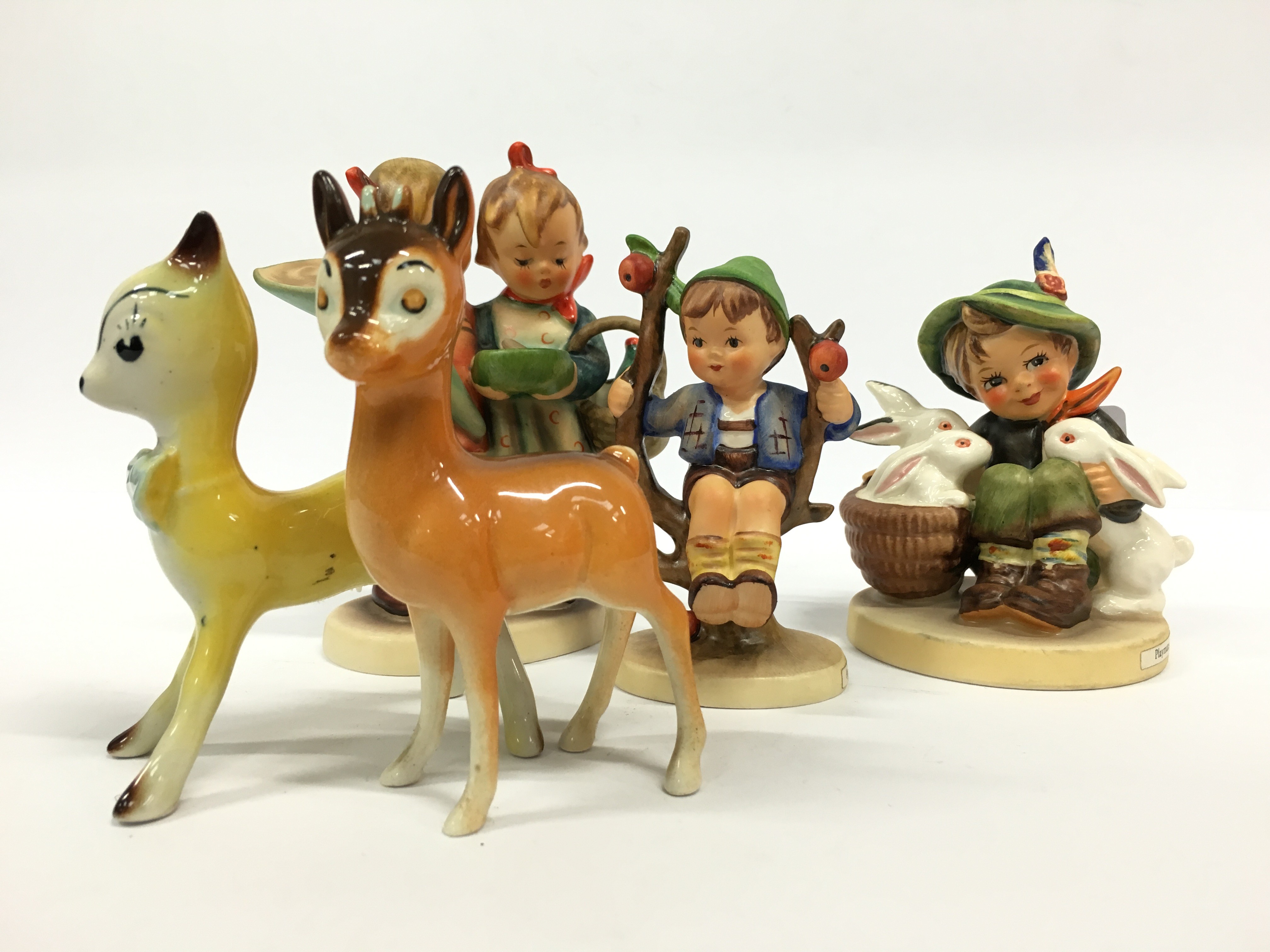 Three various Goebel china Hummel figures together with  a Beswick Babycham Bambi and similar