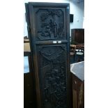 A heavily carved Chinese hardwood four fold screen with panels depicting figures and foliage.