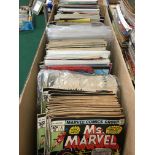 A box containing a large quantity of various Marvel and other American comics.