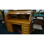 A large oak modern reproduction roll-top desk with eight drawers below and centre drop-down panel