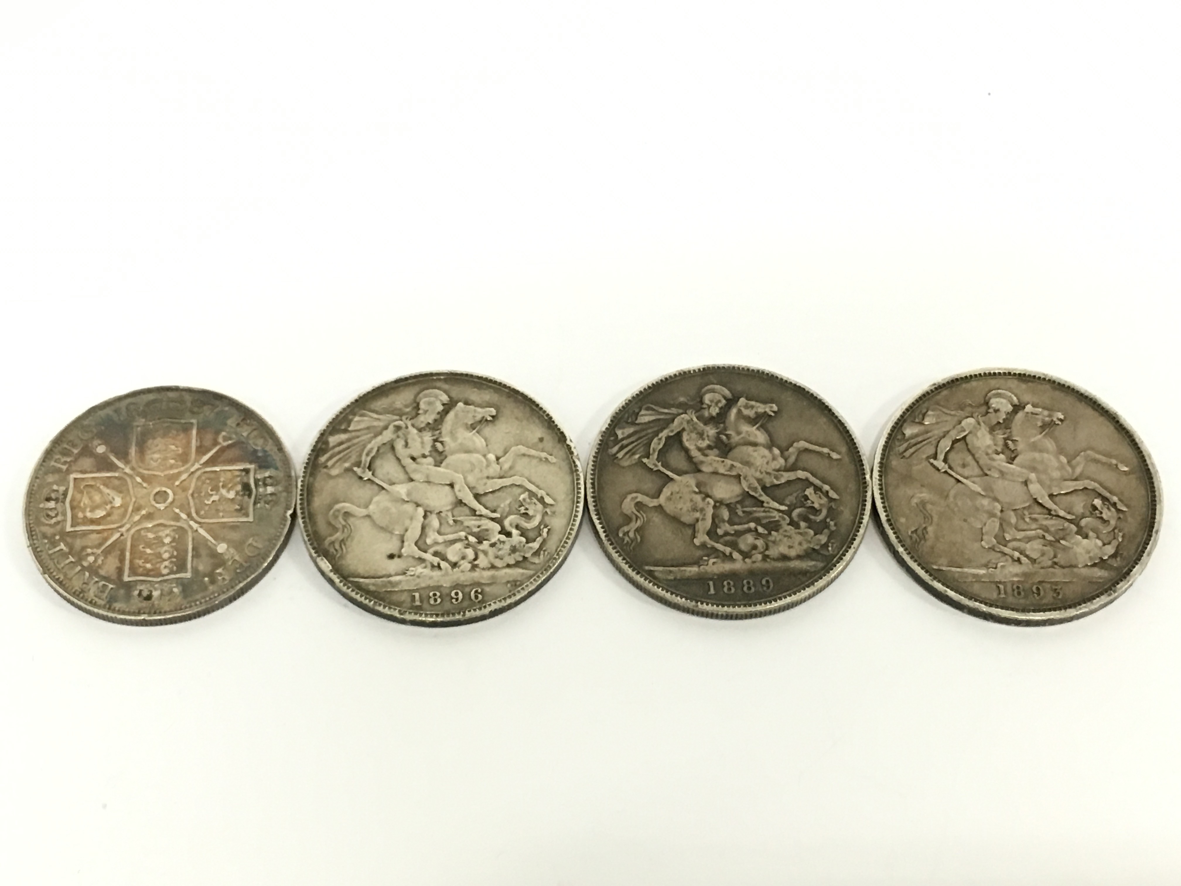 Three Victorian silver Crowns: 1889, 1893 and 1896 together with an 1887 half Crown.