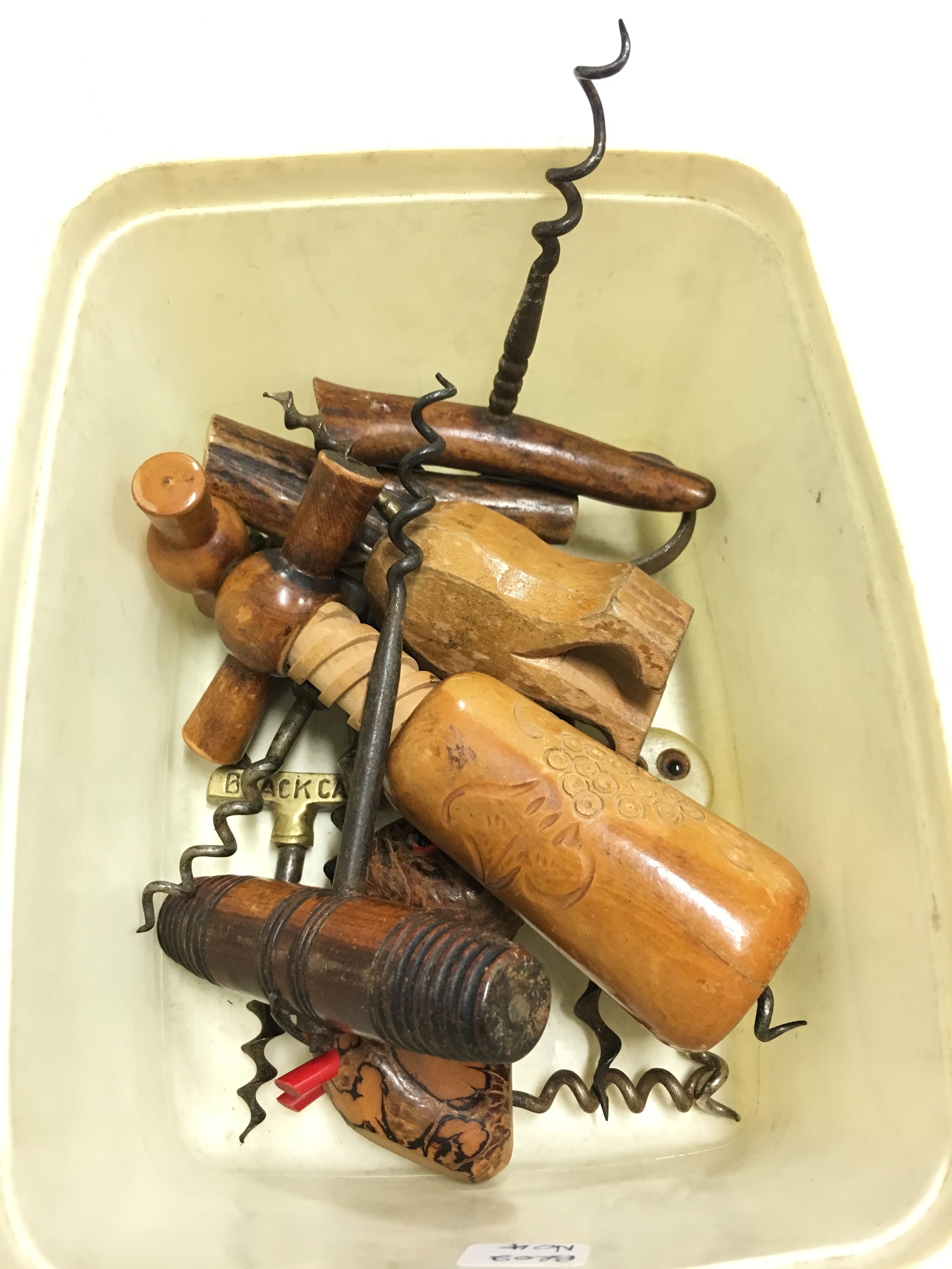 A carton of various wooden corkscrews.