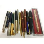 A carton of various fountain and ball point pens.
