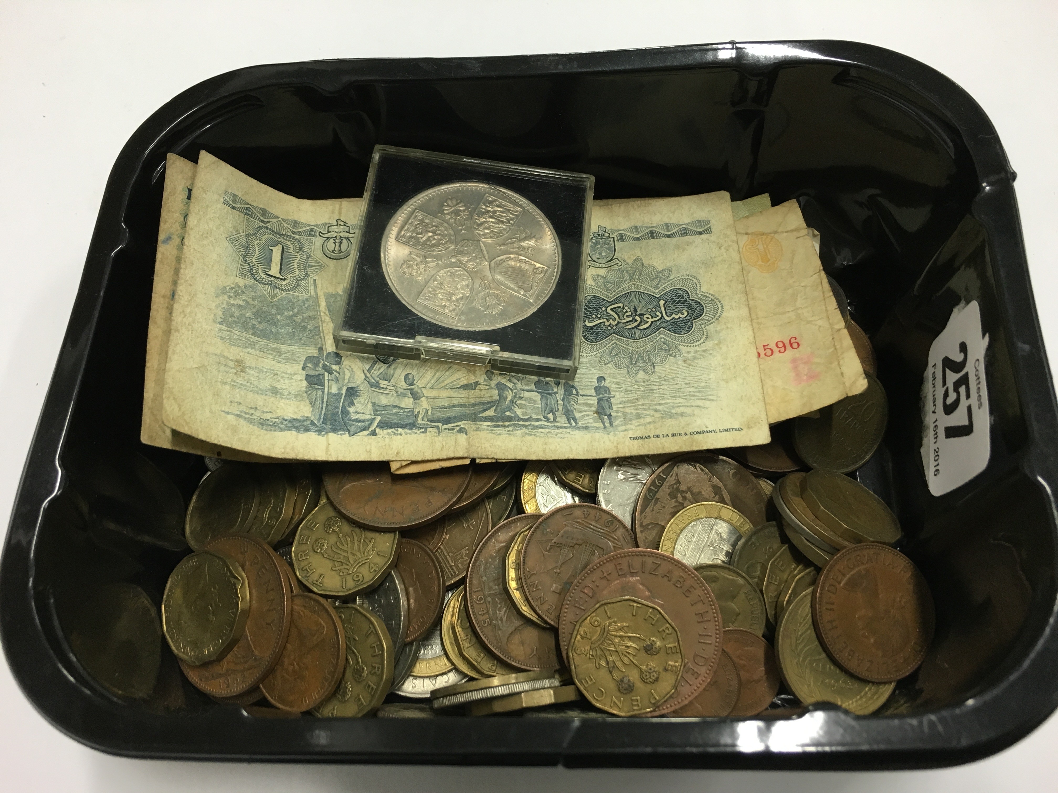 A carton of various coins.
