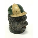 A cold painted bronze inkwell modelled as a dog wearing a jockey cap.