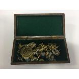 A wooden box containing a quantity of costume jewellery.