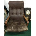 A mid 20th century retro teak framed brown leather button back swivel armchair.