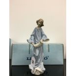 A Lladro china figure modelled as a girl in long dress playing a squeeze box.
