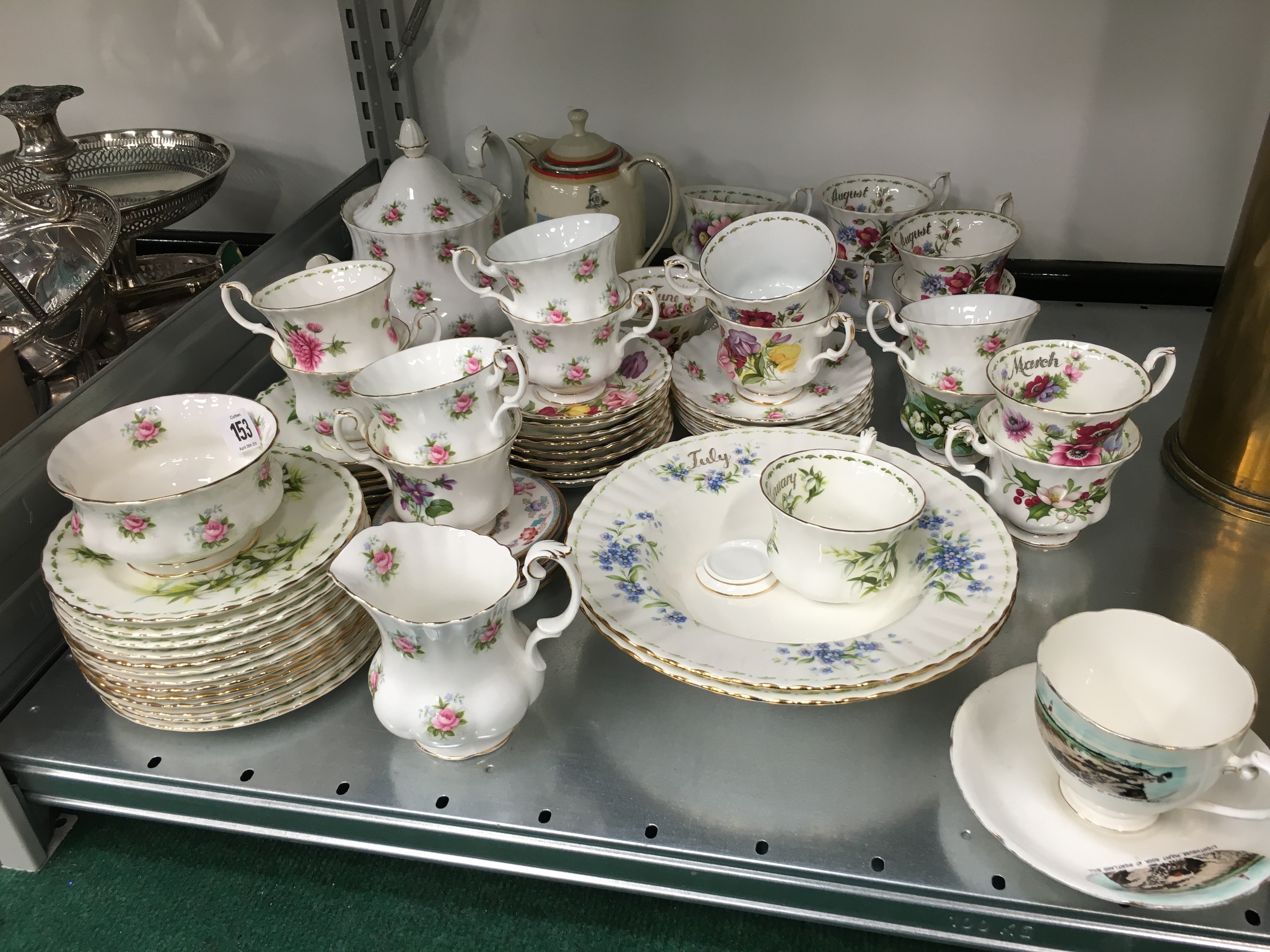 A quantity of Royal Albert bone china tea cups and saucers in the Month of the Year Series.