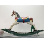 A small painted wooden rocking horse.