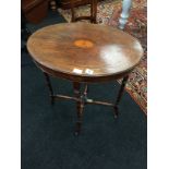 A Victorian rosewood and satinwood inlaid ladies work table resting on turned supports and castors.